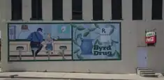 A Norman Rockwell painting on the side of Byrd Drugs in downtown Troy